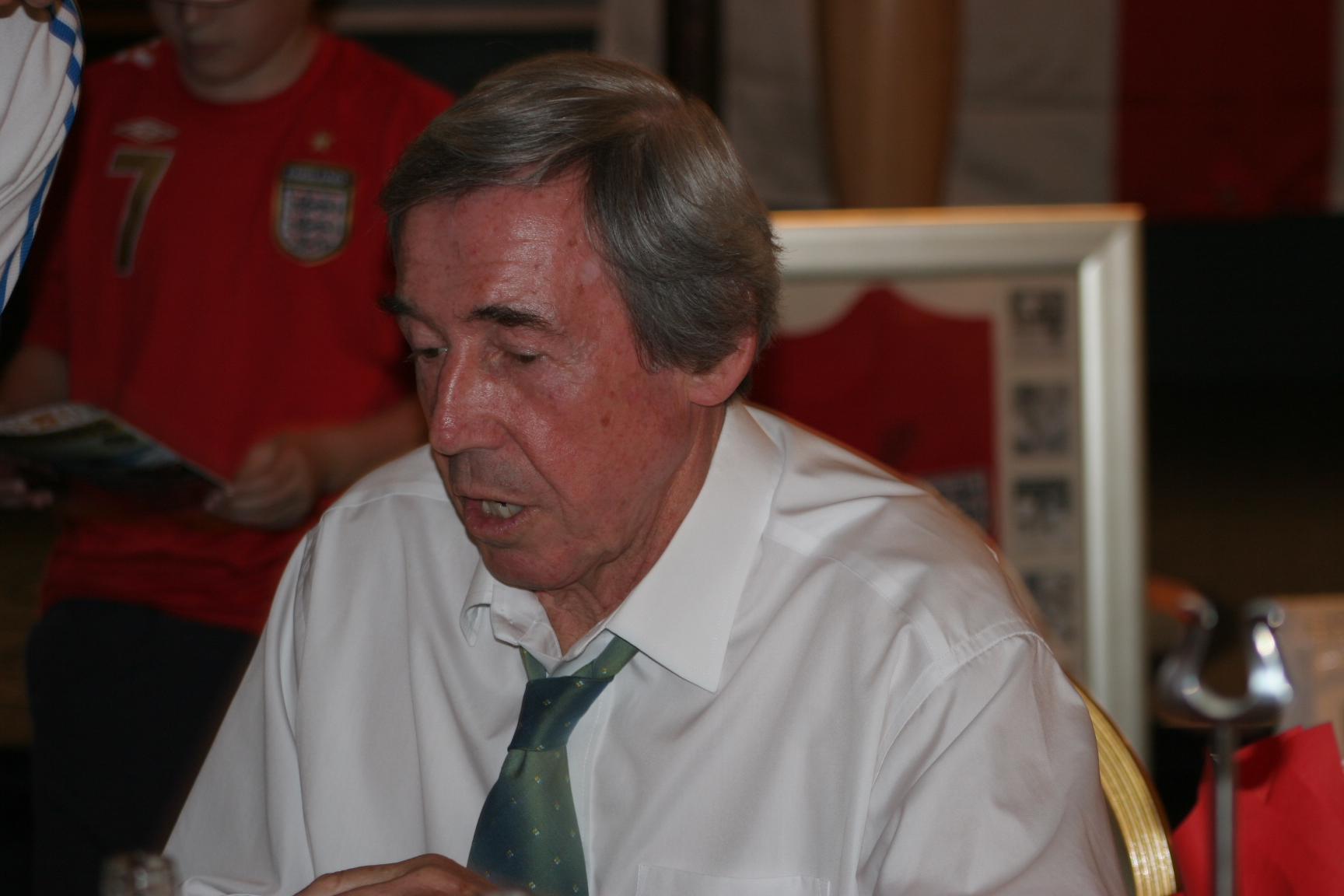 Gordon Banks seated, signing